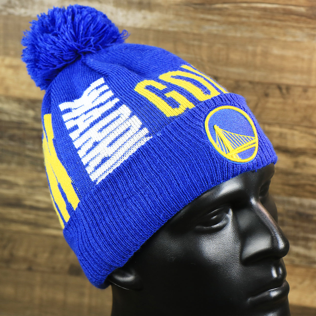 The Golden State Warriors Wrapped Around Wordmark Pom Pom Winter Beanie | Blue Winter Beanie
