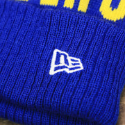 The New Era Logo on the Golden State Warriors Wrapped Around Wordmark Pom Pom Winter Beanie | Blue Winter Beanie