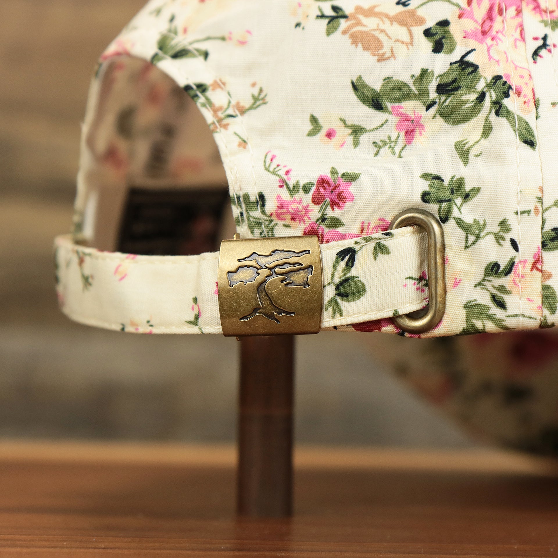 The metallic buckle on the Kid’s Floral Print Blank Adjustable Baseball Hat | Youth Cream Dad Hat