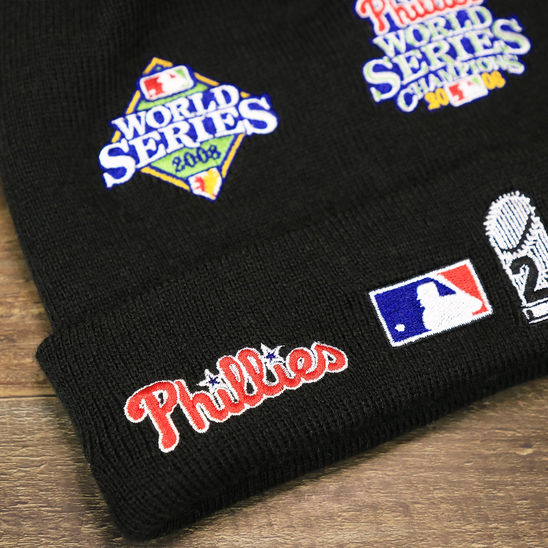 The Phillies Wordmark on the Philadelphia Phillies All Over World Series Side Patch 2x Champion Knit Cuff Beanie | New Era, Black
