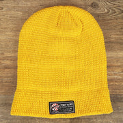 The backside of the Mustard Golden Yellow Fisherman Knit Cuffed Beanie