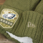 The New Era Logo on the Women’s Philadelphia Eagles Salute To Service Ribbon Rubber Military Eagles Patch On Field NFL Beanie | Women’s Military Green Beanie
