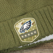 The Eagles Logo on the Women’s Philadelphia Eagles Salute To Service Ribbon Rubber Military Eagles Patch On Field NFL Beanie | Women’s Military Green Beanie
