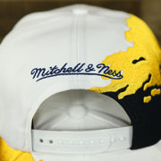 mitchell and ness logo on the University of Michigan Vintage Retro NCAA Paintbrush Mitchell and Ness Snapback Hat | Yellow/Navy Blue/White