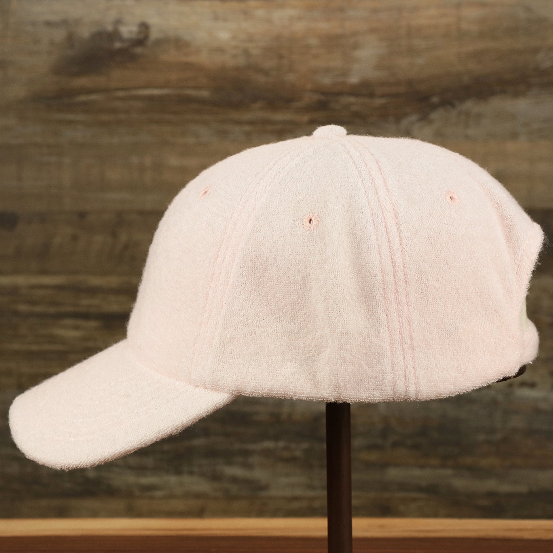 The wearer's left of the Blank Misty Rose Wash Cloth Baseball Hat | Light Pink Dad Hat