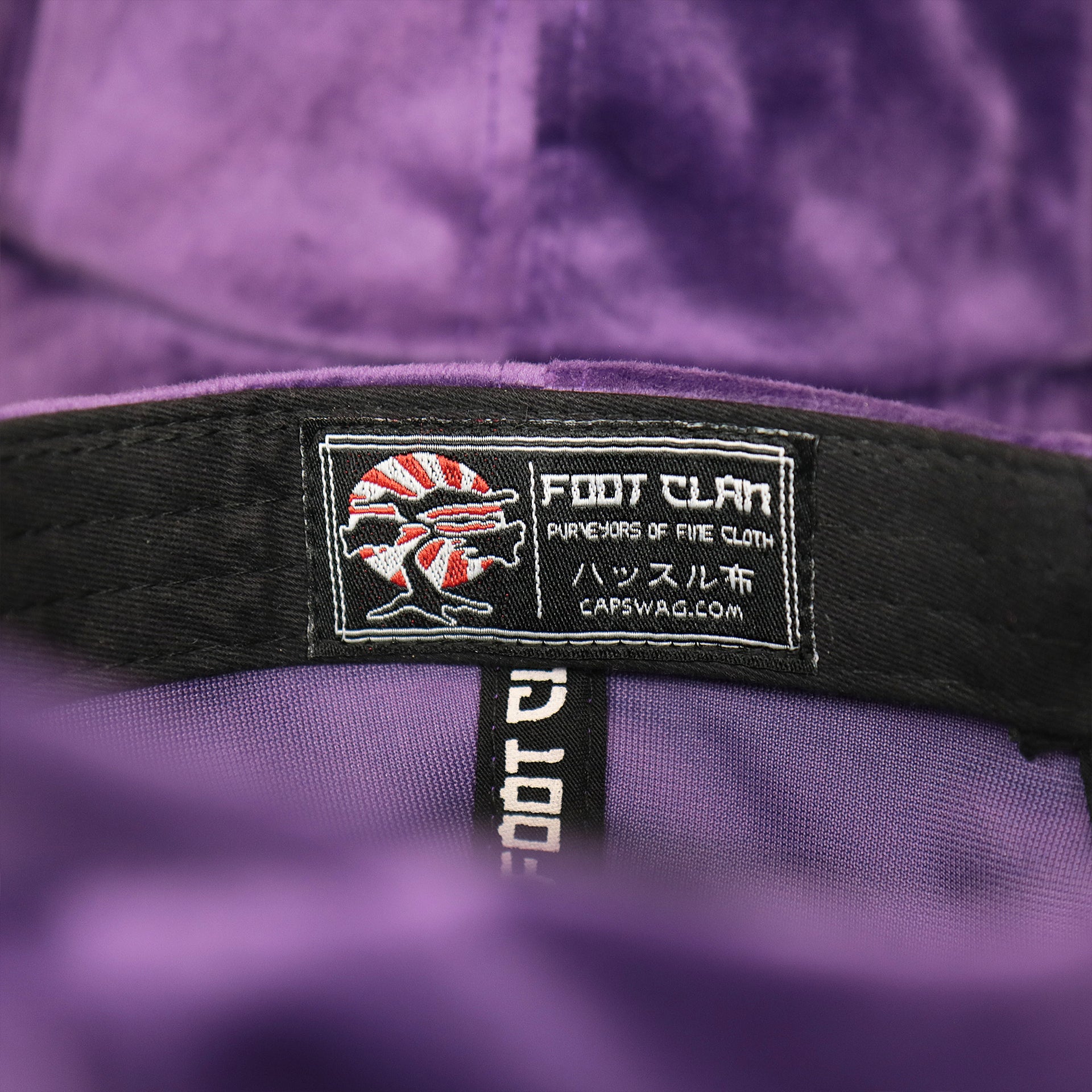 The Foot Clan Tag on the Velour Blank Concord Grape Baseball Hat | Purple Dad Hat