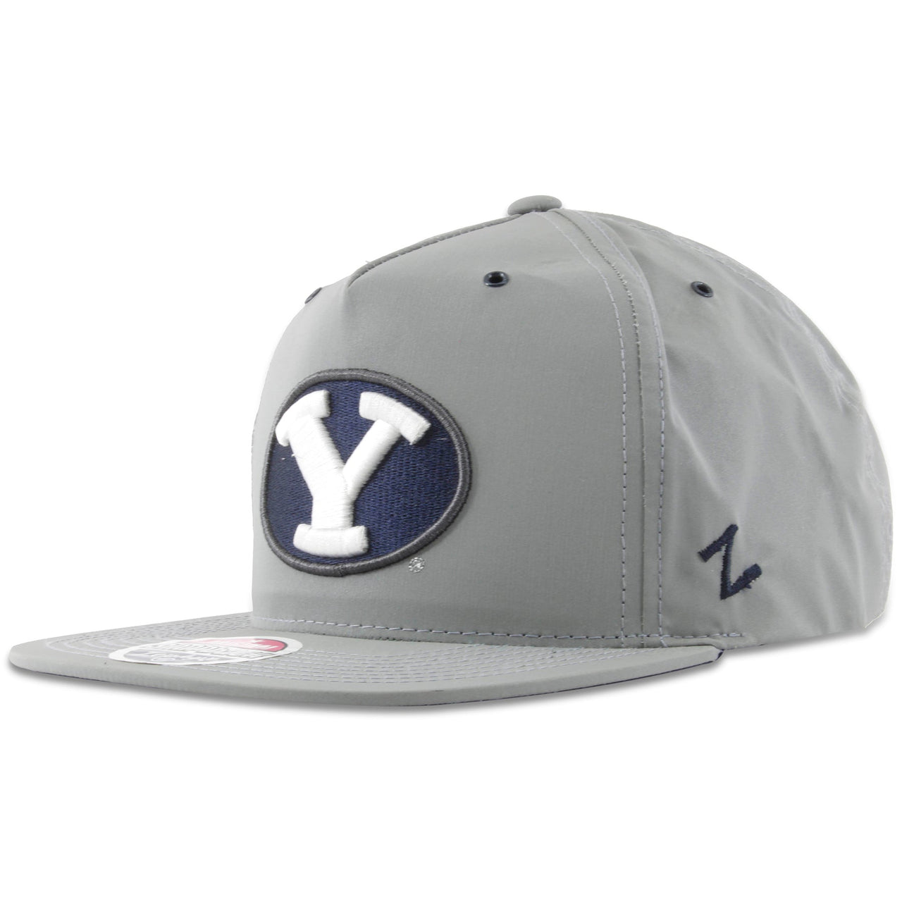 On the left side of the BYU gray reflective adjustable snapback hat is the Zephyr logo embroidered in navy blue