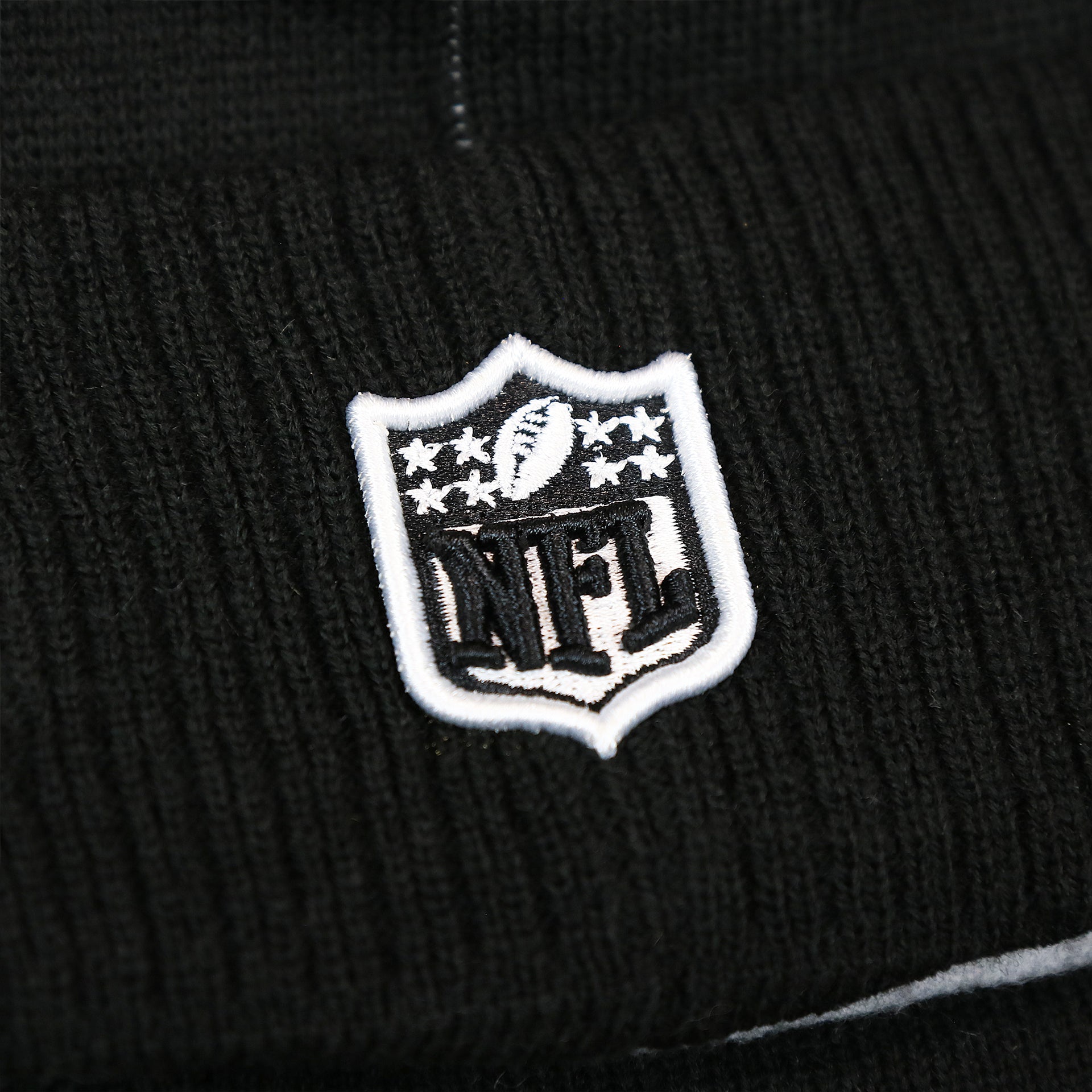 The NFL Logo on the Philadelphia Eagles On Field Cuffed Winter Pom Pom Beanie | Black And White Winter Beanie