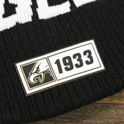 The Rubber 1933 Patch on the Philadelphia Eagles On Field Cuffed Winter Pom Pom Beanie | Black And White Winter Beanie