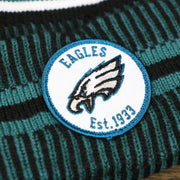 The Eagles Patch on the Philadelphia Eagles Patch 1933 On Field Striped Eagles Colorway Pom Pom Winter Beanie | Black and Midnight Green Winter Beanie