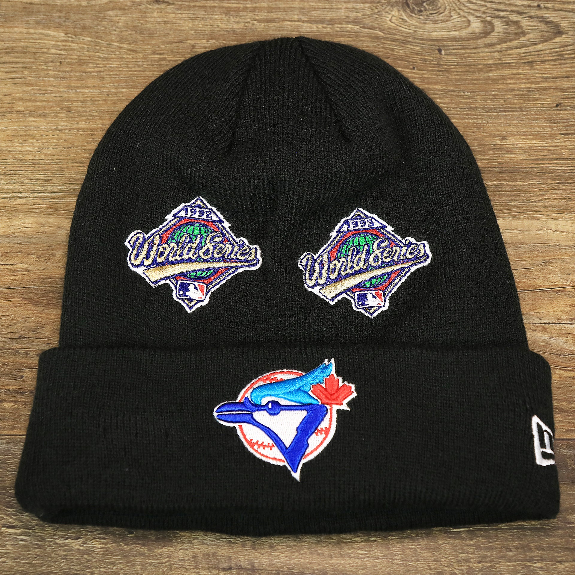 The front of the Toronto Blue Jays All Over World Series Side Patch 2x Champion Knit Cuff Beanie | New Era, Black