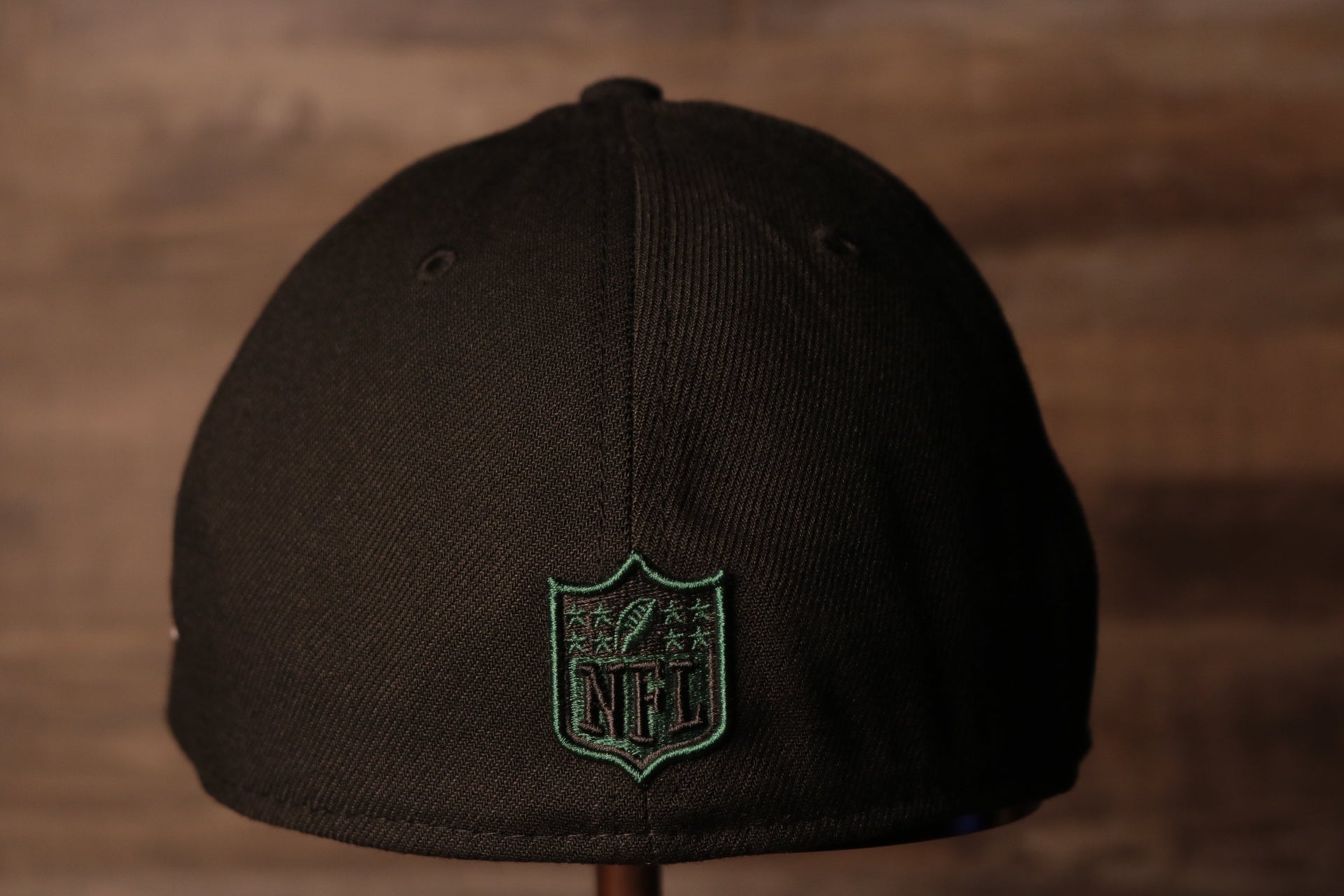 The nfl shield is on the back of this cap Jets 2020 NFL Draft Flexfit | New York Jets 2020 NFL Draft Black Stretch Fit