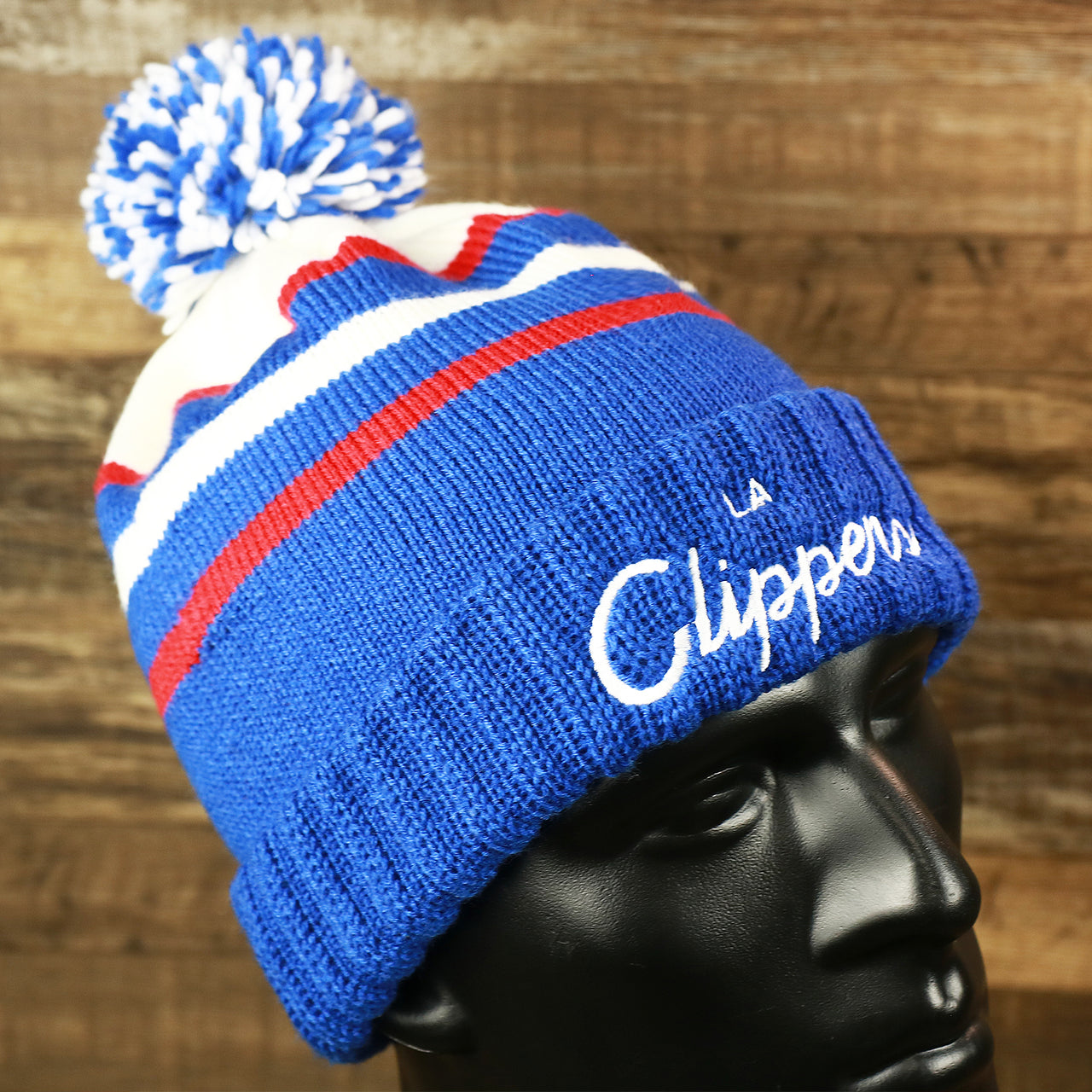 The Los Angeles Clippers Cursive Wordmark Blue Cuff Pom Pom Winter Beanie | Blue Striped Winter Beanie