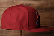 the wearers right side is plain burgundy Grey Bottom Fitted Cap | Jawn Burgundy Gray Bottom Fitted Hat