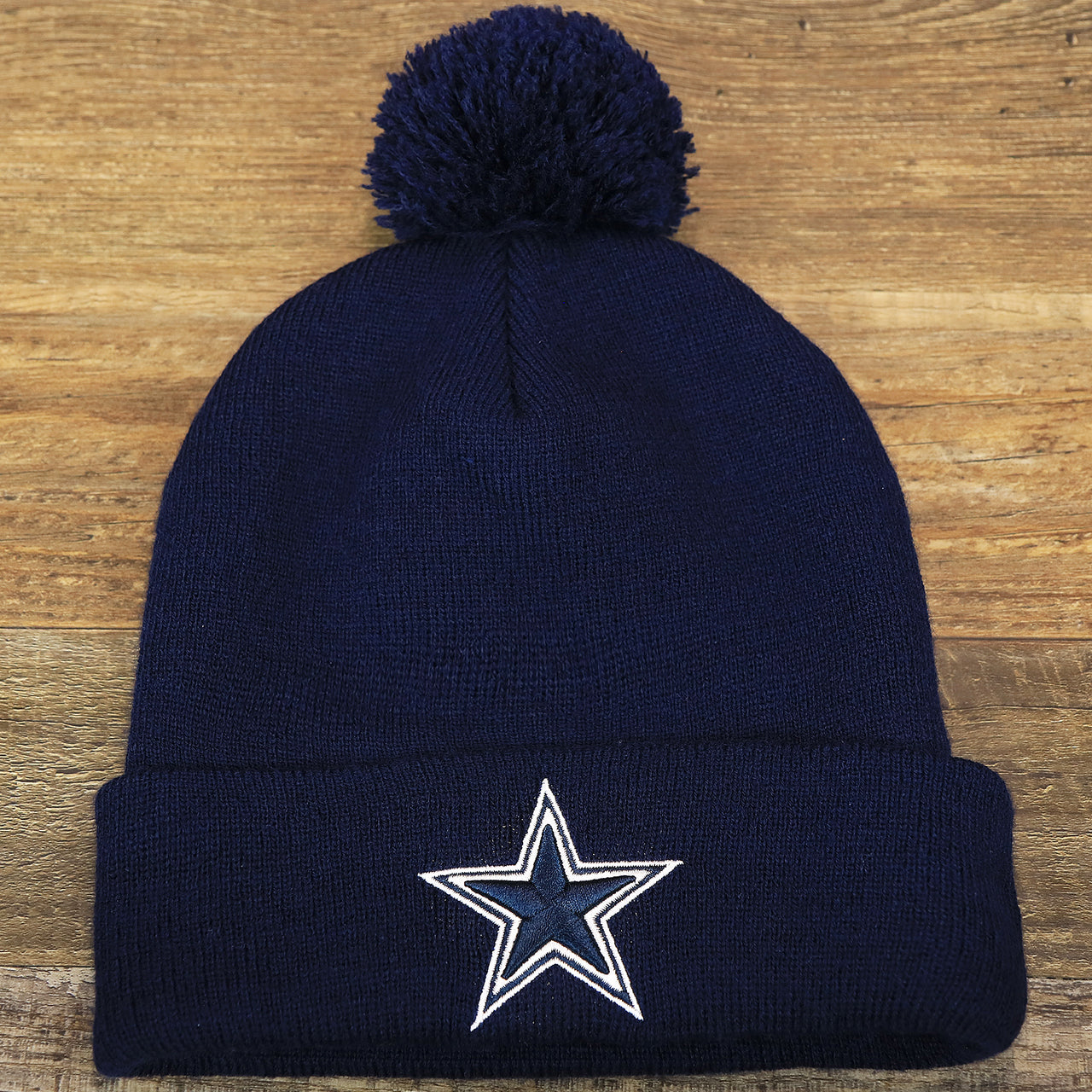 The front of the Dallas Cowboys Authentic Series Pom Pom Winter Beanie | Navy Blue Winter Beanie