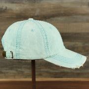 The wearer's right on the Washed Pigment Blank Distressed Baseball Hat | Washed Mint Dad Hat