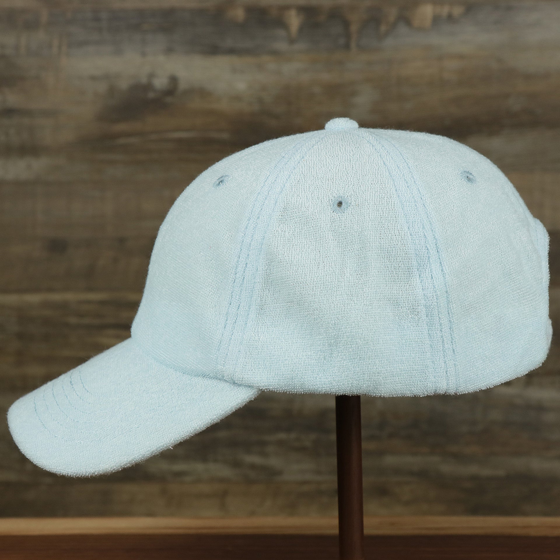 The wearer's left of the Blank Alice Blue Wash Cloth Baseball Hat | Light Blue Dad Hat
