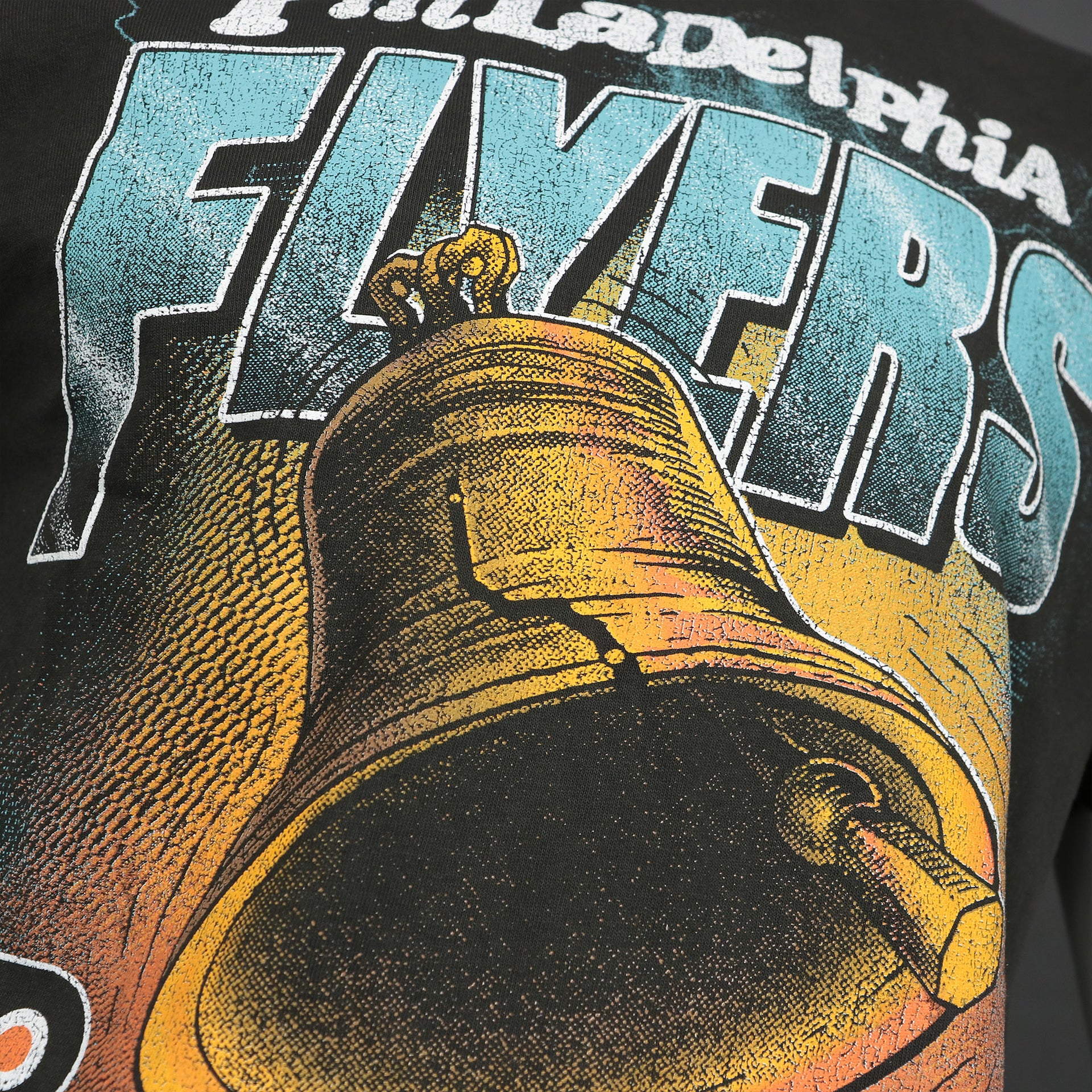Liberty Bell logo on the front side of the Philadelphia Flyers Liberty Bell Vintage Tubular Distressed T-Shirt | Flint Black