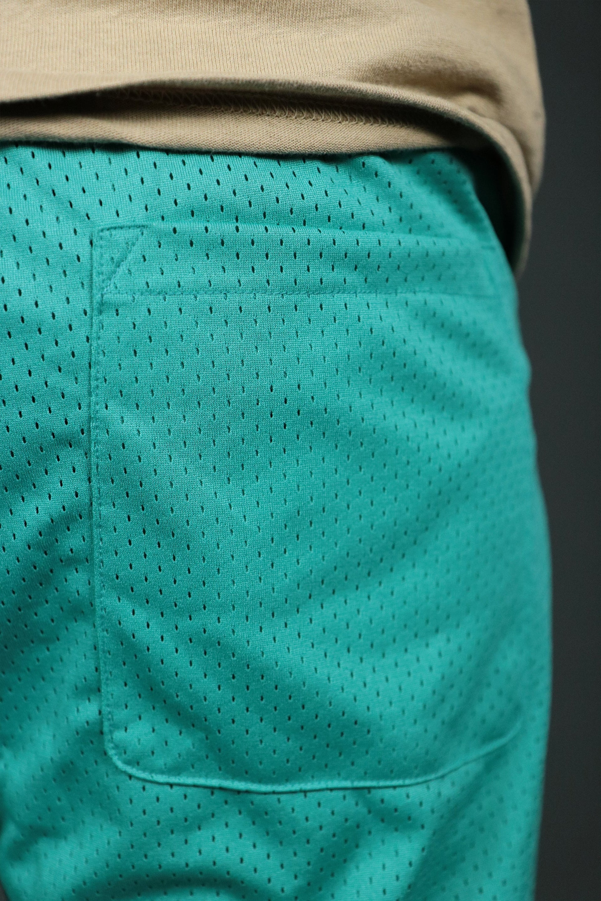The back pocket of the aqua retro San Antonio hooping shorts by Jordan Craig.