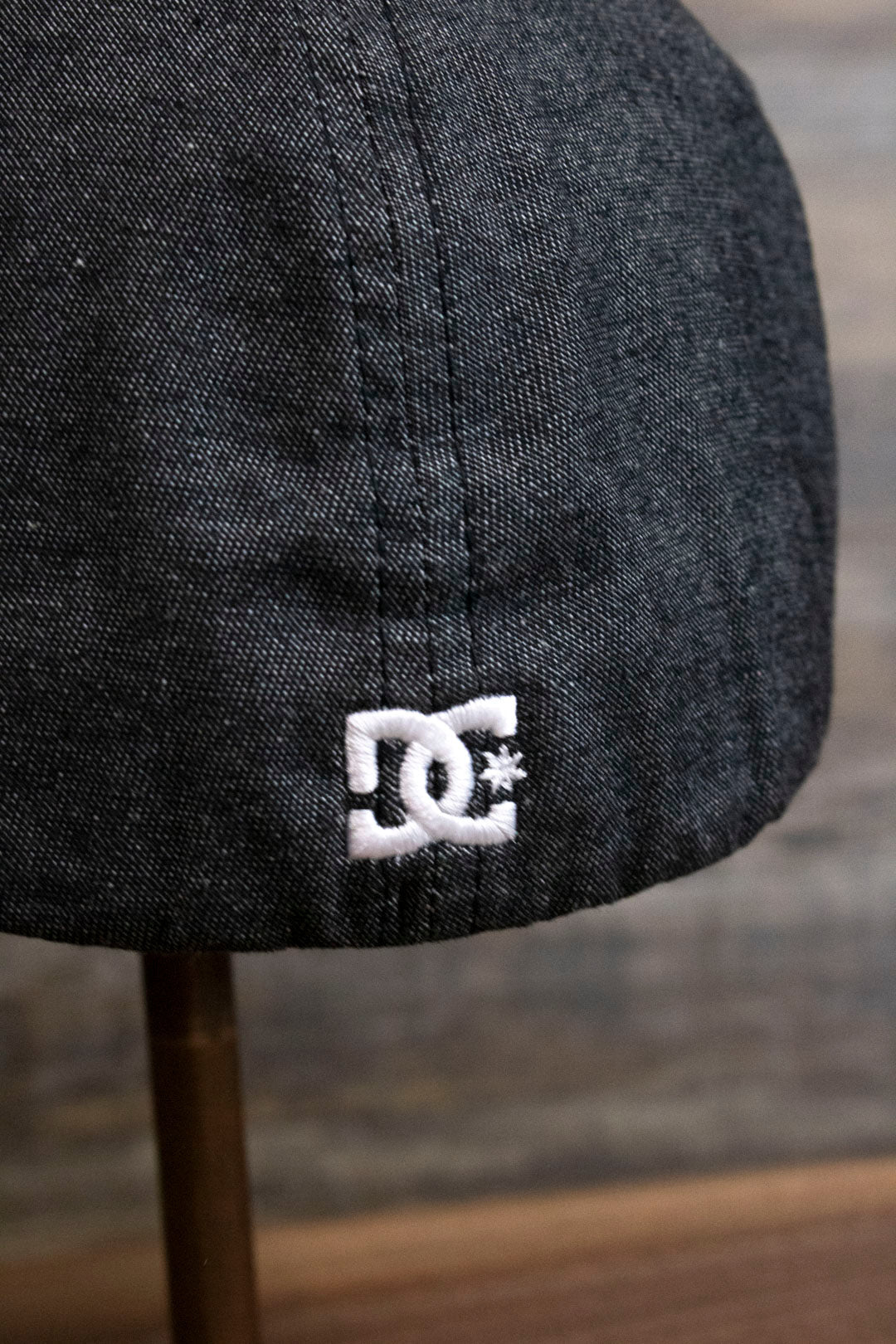 the Dark Gray Bentbrim Skater Hat | DC Shoes Black Bottom Heather Gray Flexfit Cap has a tiny DC logo on the back