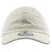 The ivory blank baseball cap has a soft unstructured crown and a bent brim