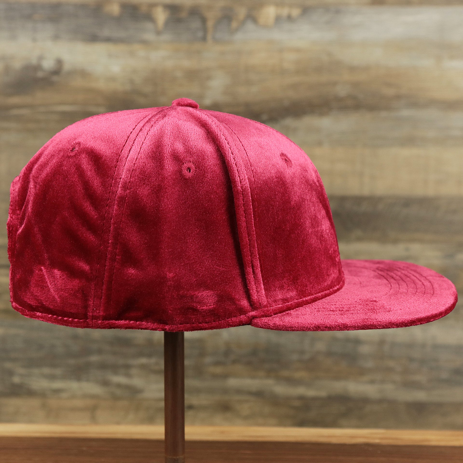 The wearer's right on the Velour Blank Ox Blood Snapback Cap | Dark Red Snap Cap