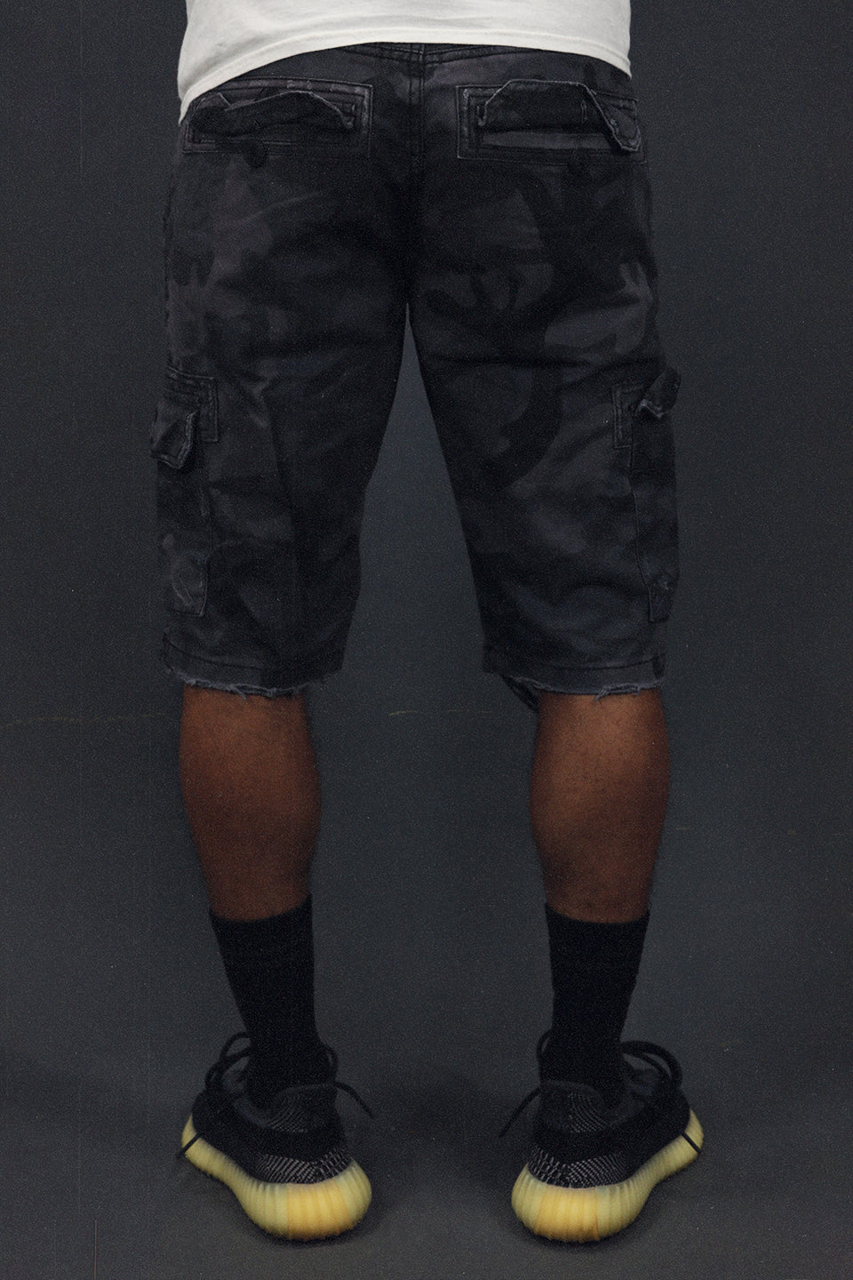 back of the Men's Ripped Black Camo Vintage Distressed Cargo Shorts | Black