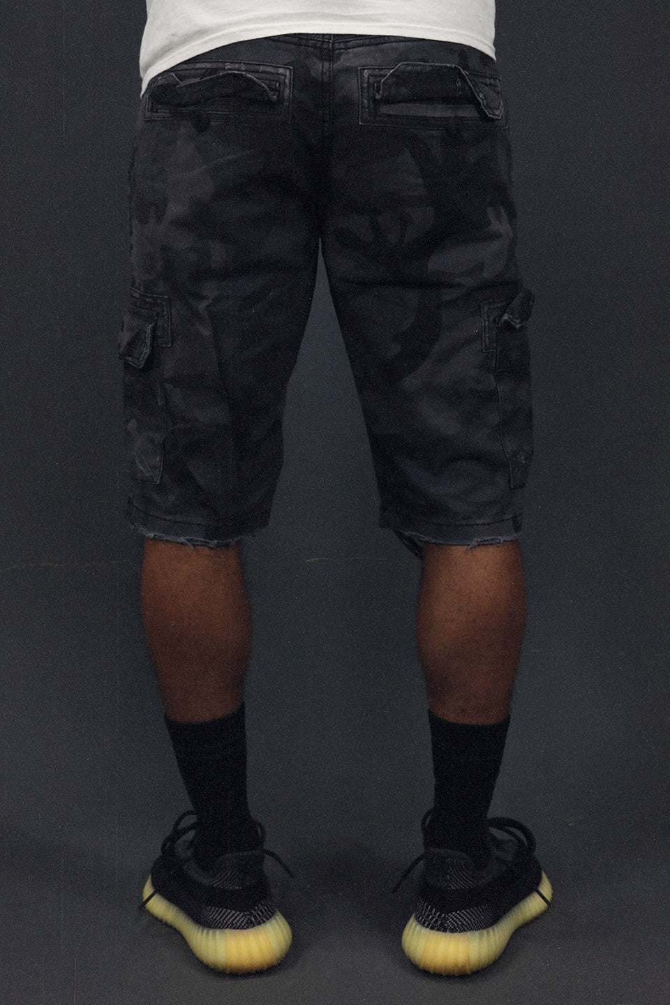 back of the Men's Ripped Black Camo Vintage Distressed Cargo Shorts | Black