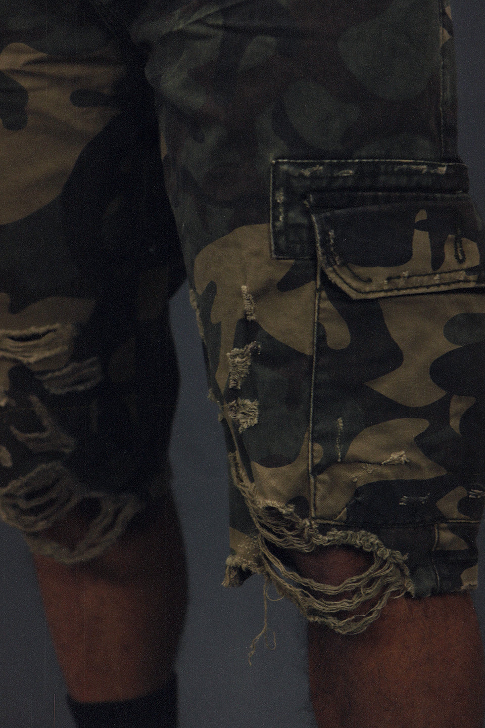 ripped shot on the Men's Ripped Woodland Camo Vintage Distressed Cargo Shorts | Woodland