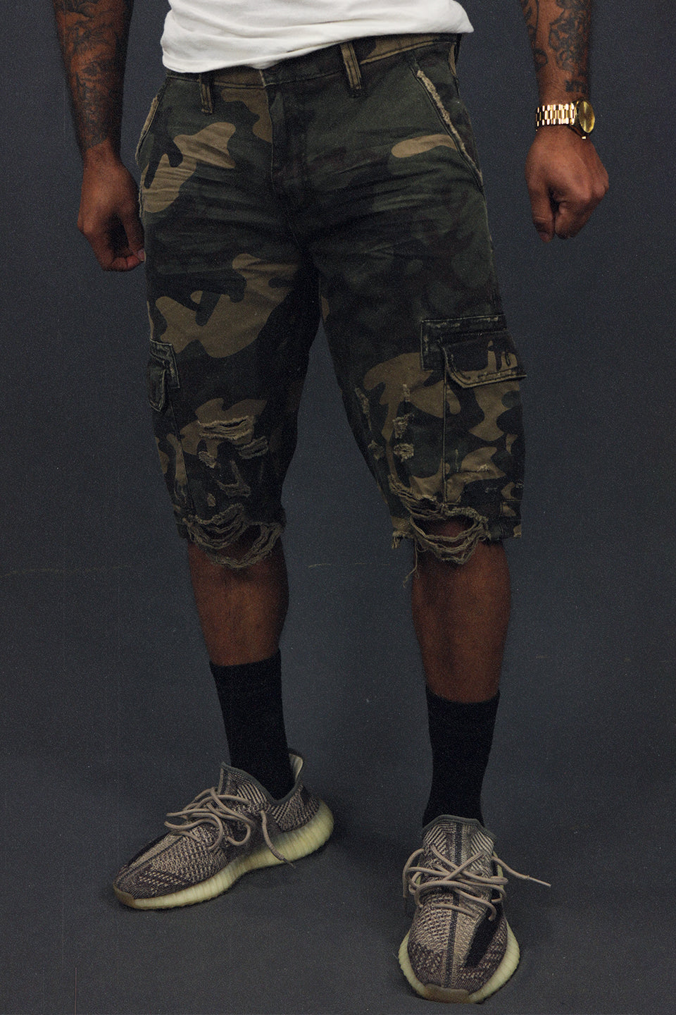 front of the Men's Ripped Woodland Camo Vintage Distressed Cargo Shorts | Woodland
