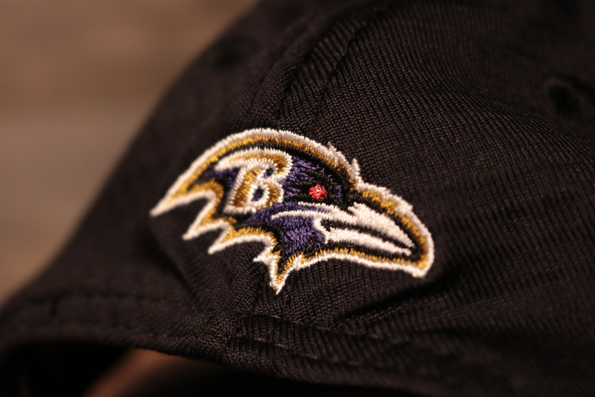 The ravens logo is right above the snap Ravens 2020 Training Camp Snapback Hat | Baltimore 2020 On-Field Black Training Camp Snap Cap