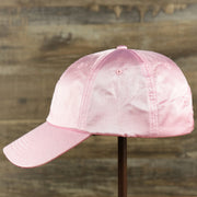 The wearer's left of the Satin Blank Cherry Blossom Pink Baseball Hat | Light Pink Dad Hat
