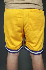 The backside of the Los Angeles running shorts with zipper pockets with purple stripes.
