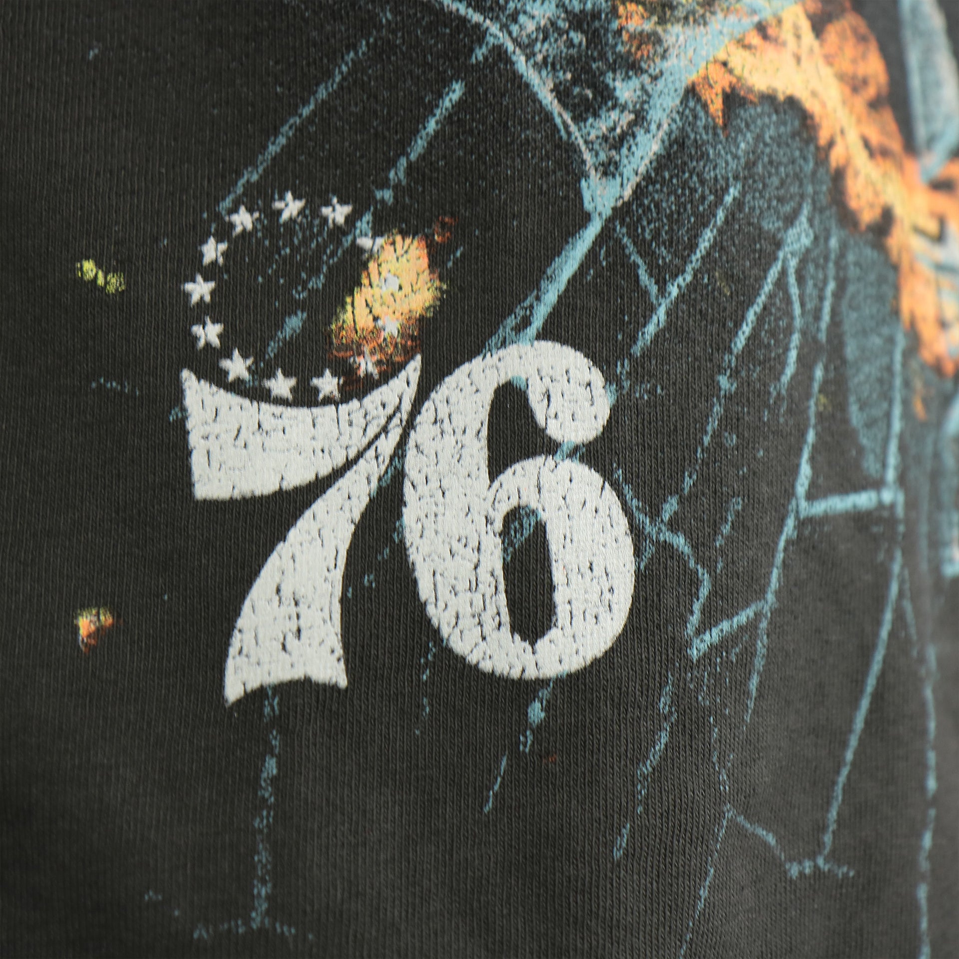 distressed 76ers logo on the front of the Philadelphia 76ers Flaming Basketball Shattering Glass Vintage Tubular Distressed T-Shirt | Flint Black