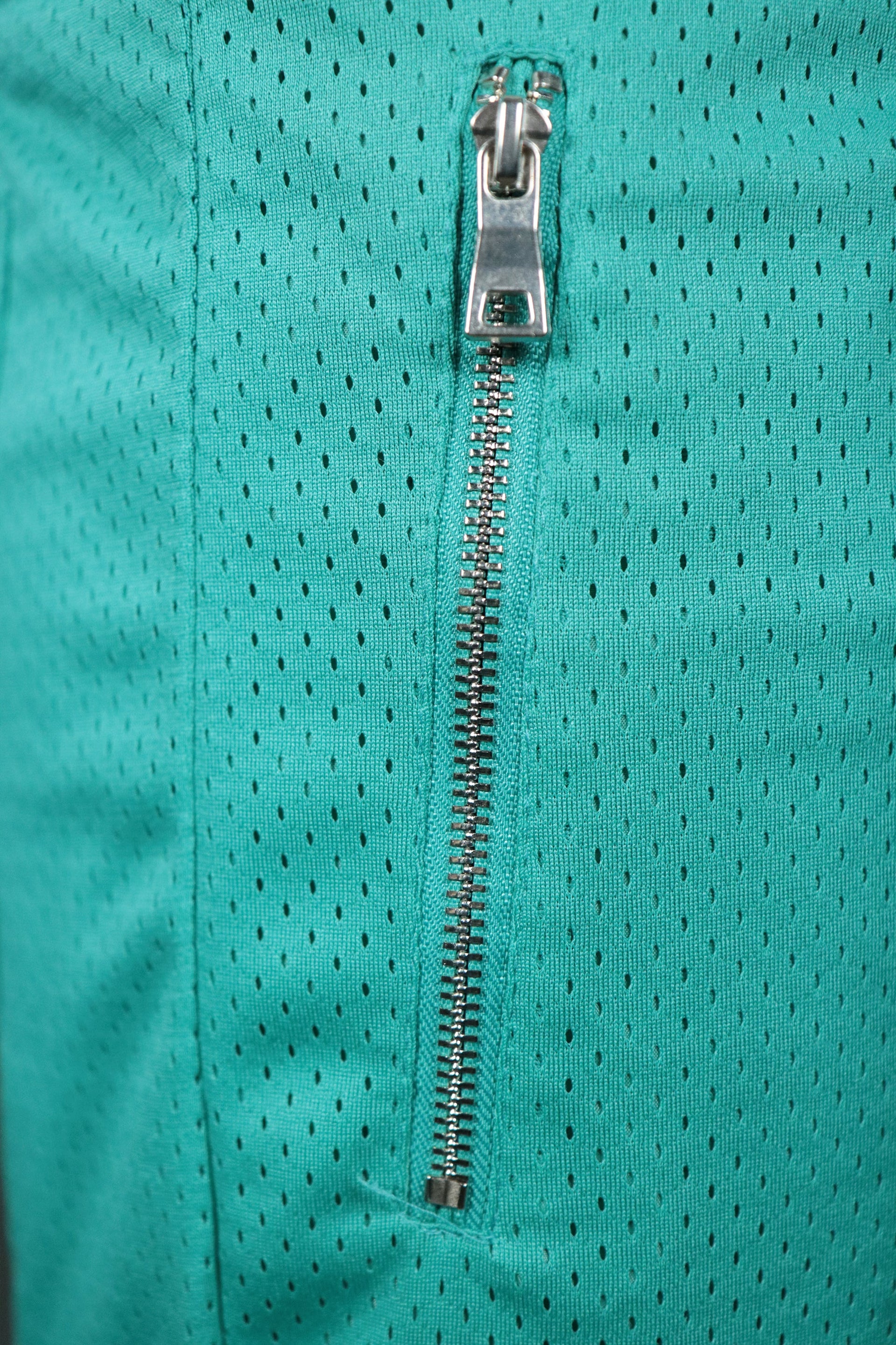 One of the metal zipped pockets of the aqua retro San Antonio basketball shorts with zipper pockets by Jordan Craig.
