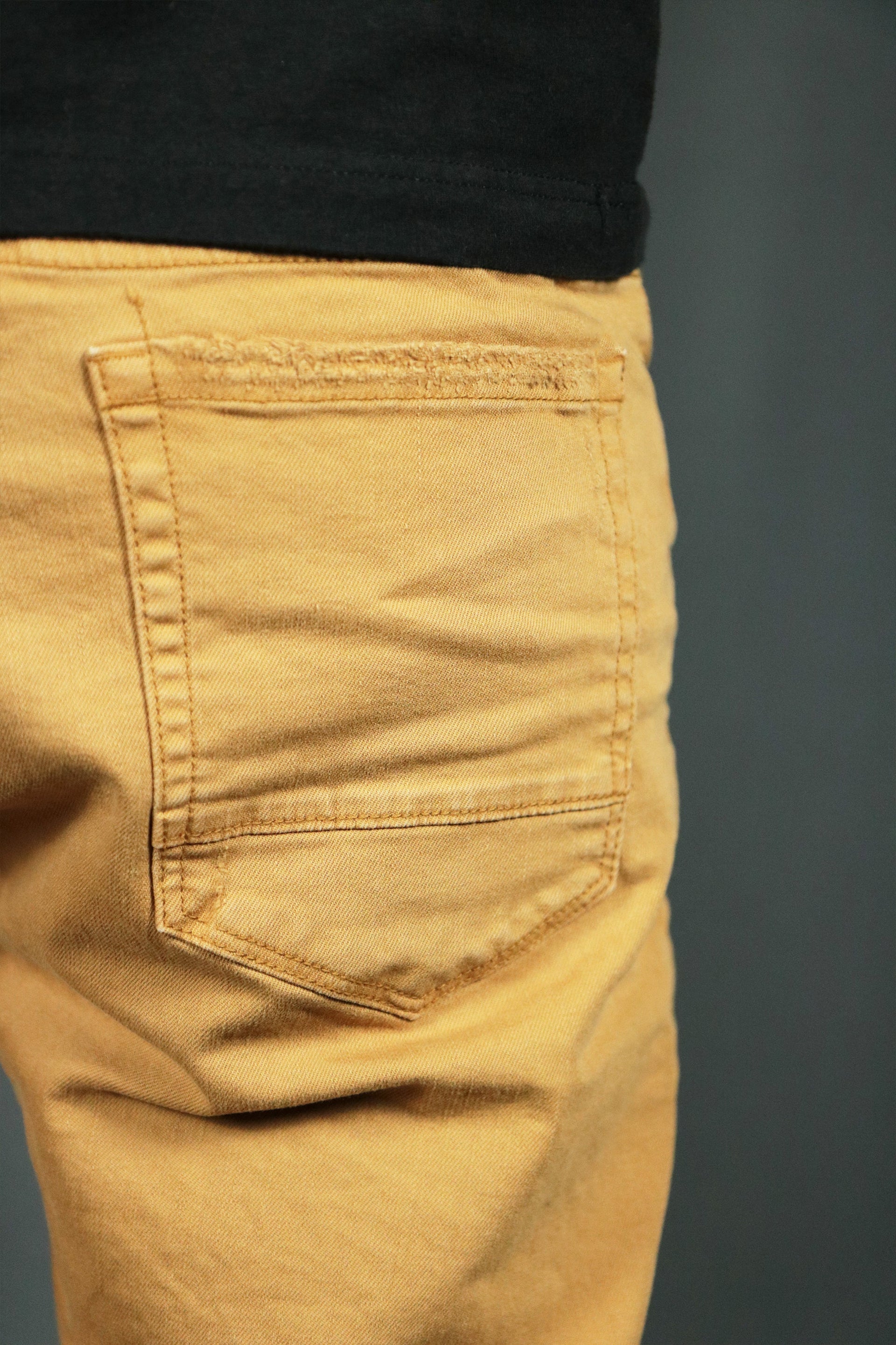 The back pocket of these khaki ripped men shorts.
