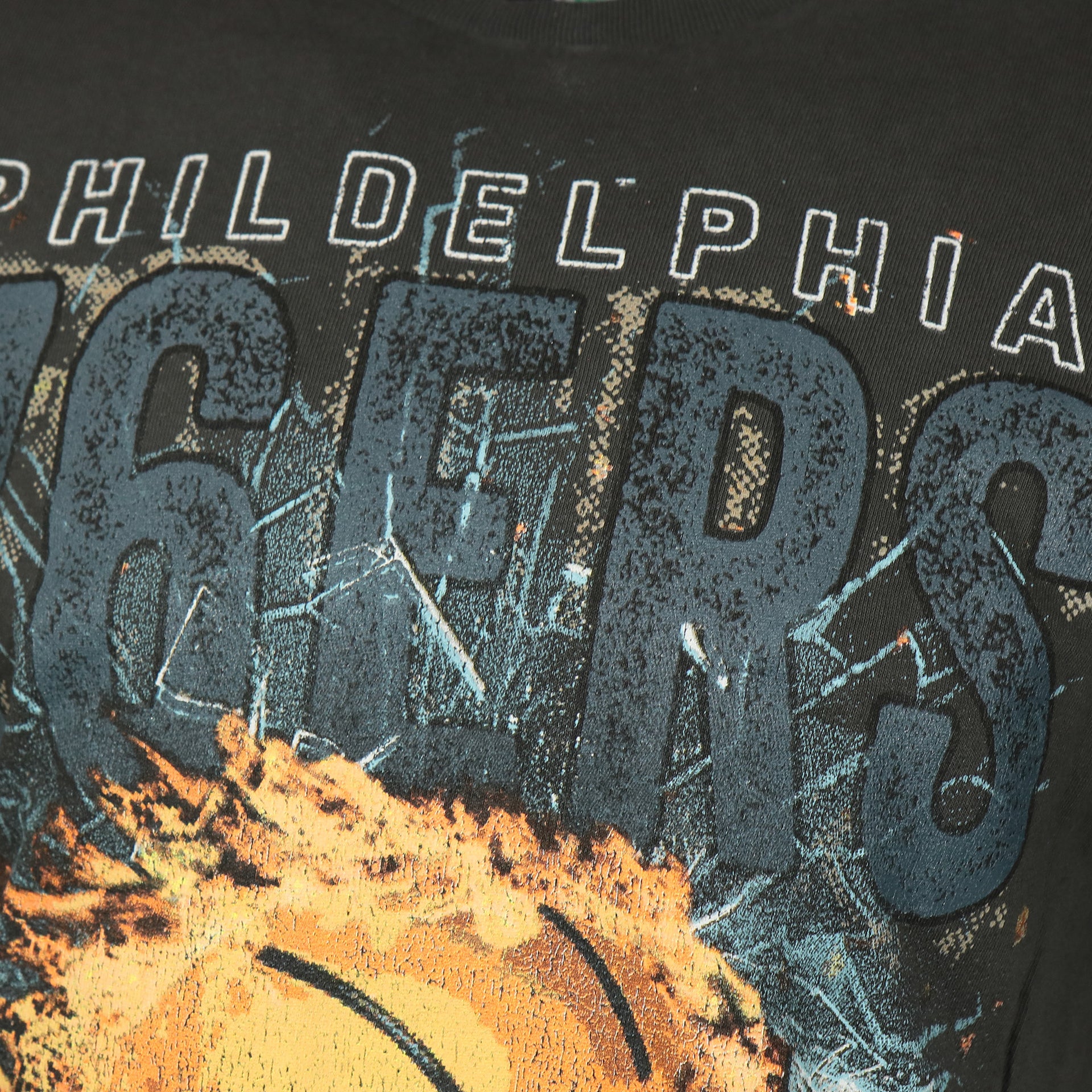 distressed 76ers name on the front of the Philadelphia 76ers Flaming Basketball Shattering Glass Vintage Tubular Distressed T-Shirt | Flint Black