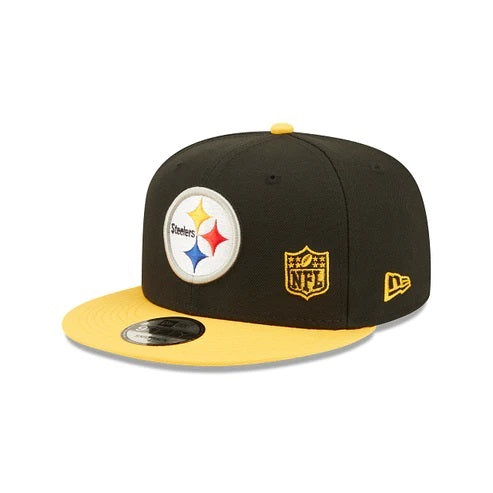 The wearer's left on the Pittsburgh Steelers Throwback Green Bottom Yellow Letter Arch 9Fifty Snapback Cap | Back Letter Arch Black 9Fifty