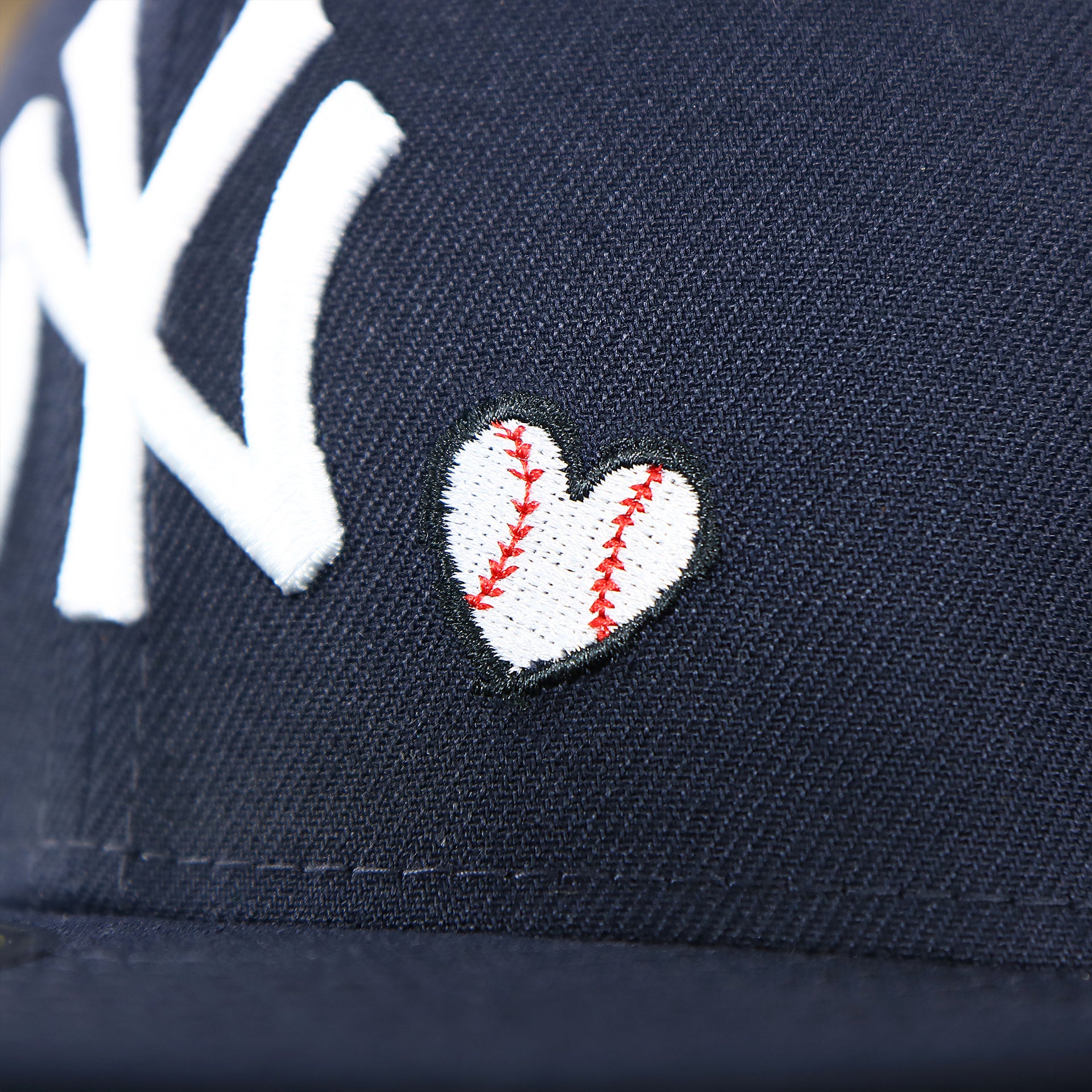 The Baseball Heart Logo on the New York Yankees Baseball Heart Gray Bottom World Series 59Fifty Fitted Cap | Navy 59Fifty Cap
