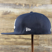 The wearer's left of the New York Yankees Baseball Heart Gray Bottom World Series 59Fifty Fitted Cap | Navy 59Fifty Cap