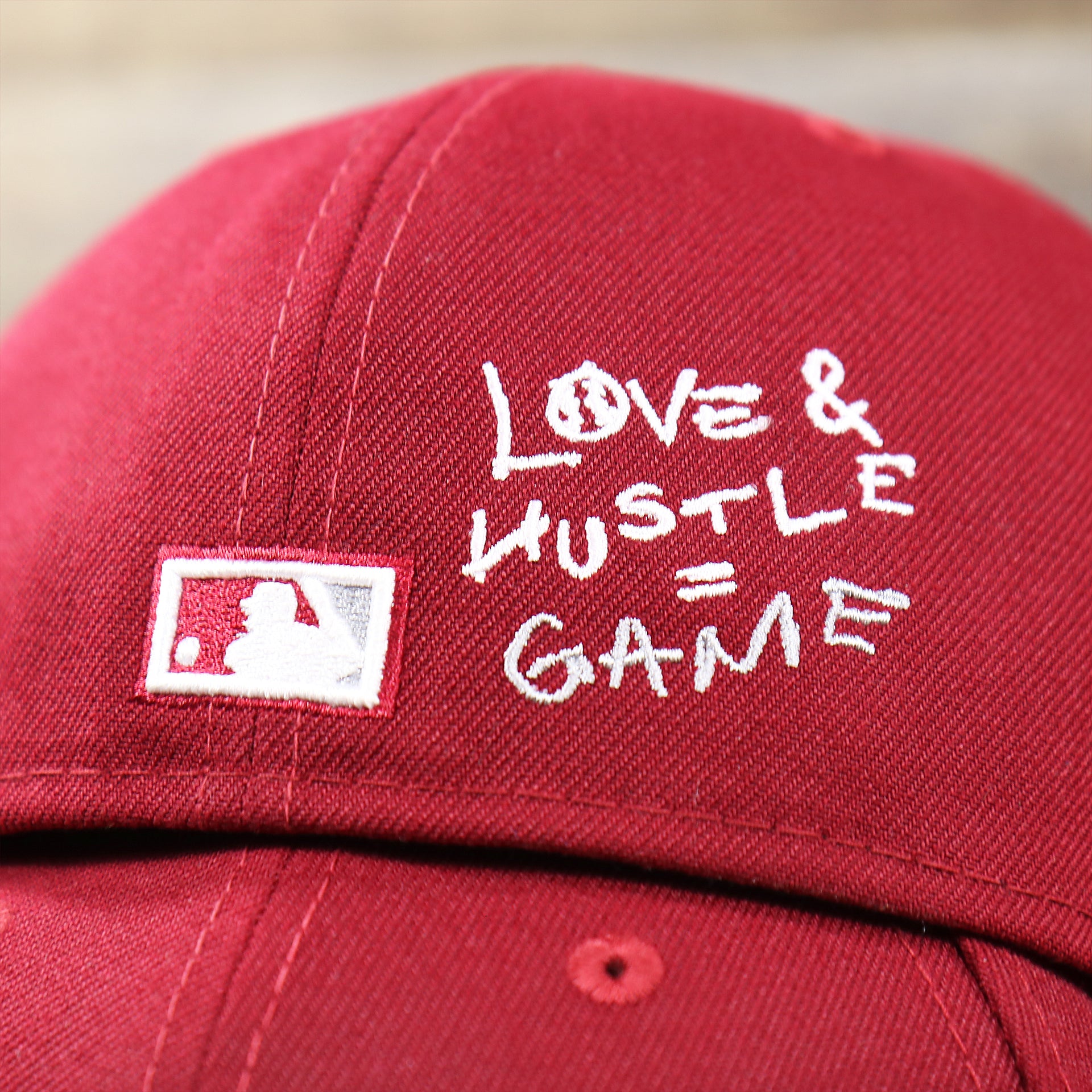 The MLB Batterman Logo with the Love & Hustle = Game text on the Cooperstown Philadelphia Phillies Baseball Heart Gray Bottom World Series 59Fifty Fitted Cap | Maroon 59Fifty Cap