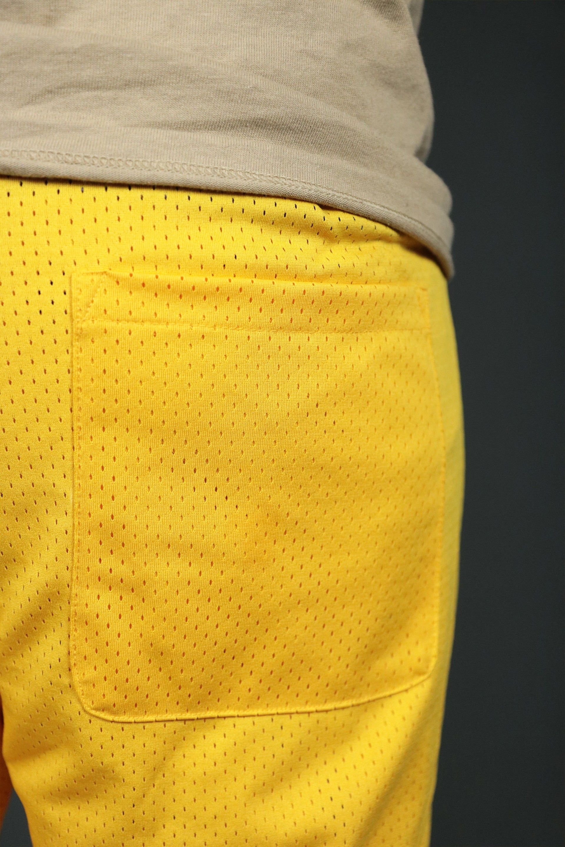 The back pocket of the yellow Los Angeles mesh basketball shorts by Jordan Craig.