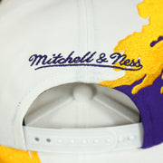 mitchell and ness logo on the Los Angeles Lakers Vintage Retro NBA Paintbrush Mitchell and Ness Snapback Hat | Purple/White/Yellow