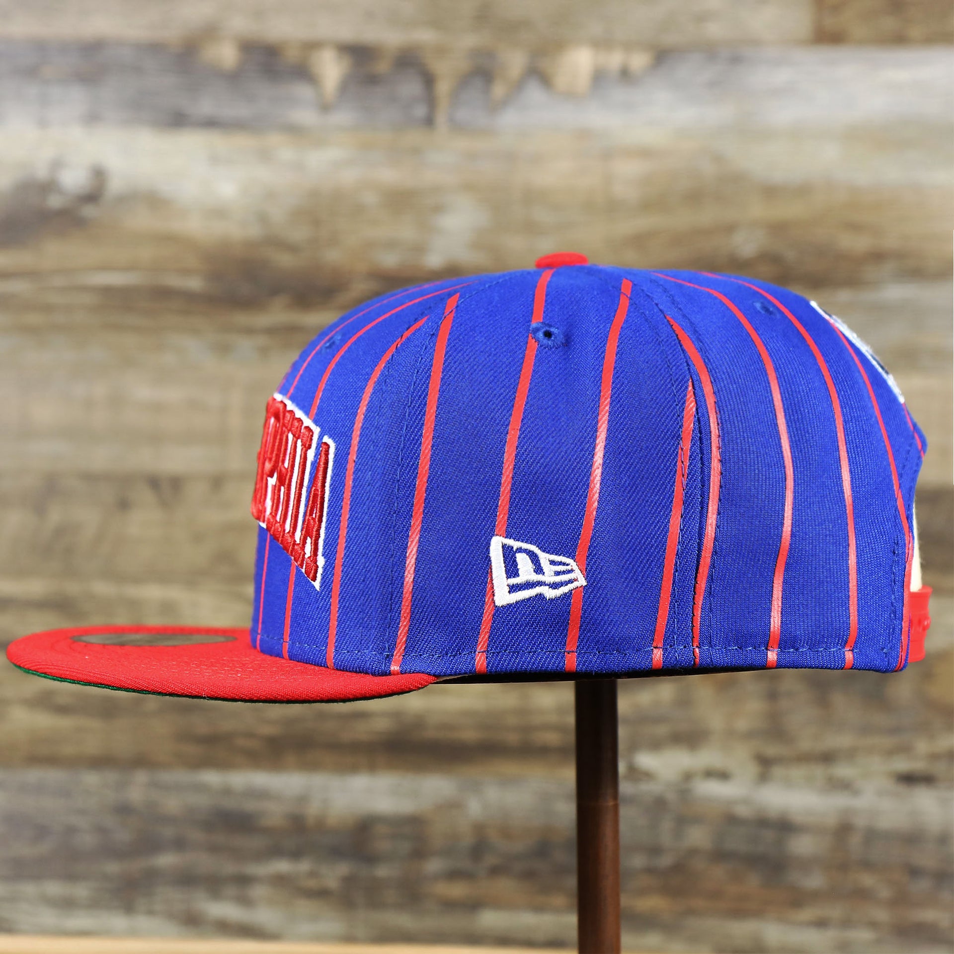 The wearer's left of the Philadelphia 76ers City Arch Striped 9Fifty Snapback Cap | Royal Blue 9Fifty Cap