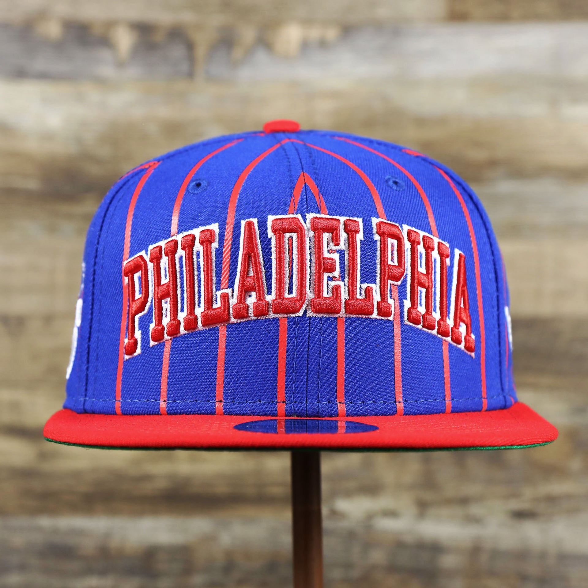The front of the Philadelphia 76ers City Arch Striped 9Fifty Snapback Cap | Royal Blue 9Fifty Cap
