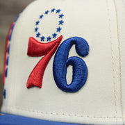 The Logo on the Philadelphia 76ers NBA 2022 Draft Gray Bottom 9Fifty Snapback | New Era Cream/Royal Blue