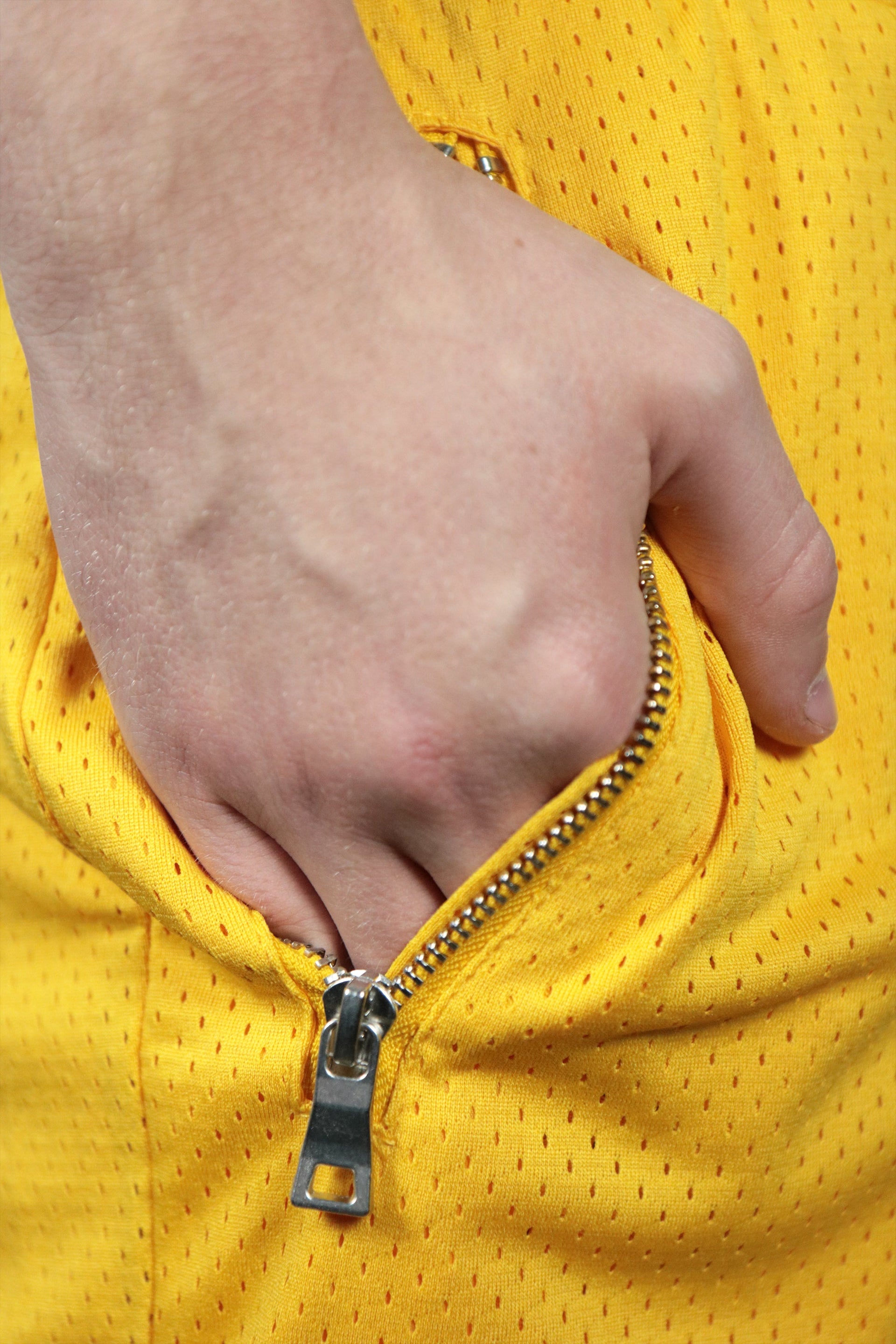The metal zipped pocket of the yellow Los Angeles swingman shorts.