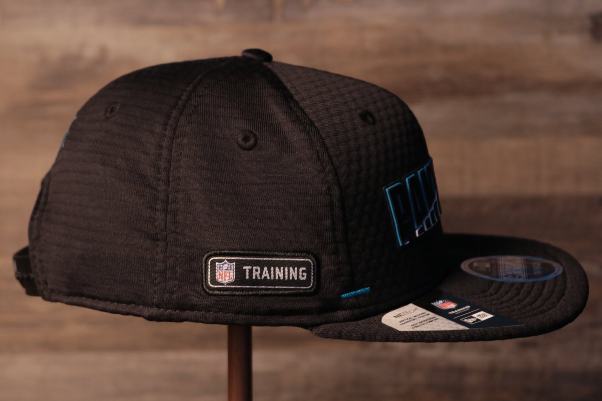 The wearers right side has the nfl training camp logo Panthers 2020 Training Camp Snapback Hat | Carolina Panthers 2020 On-Field Black Training Camp Snap Cap