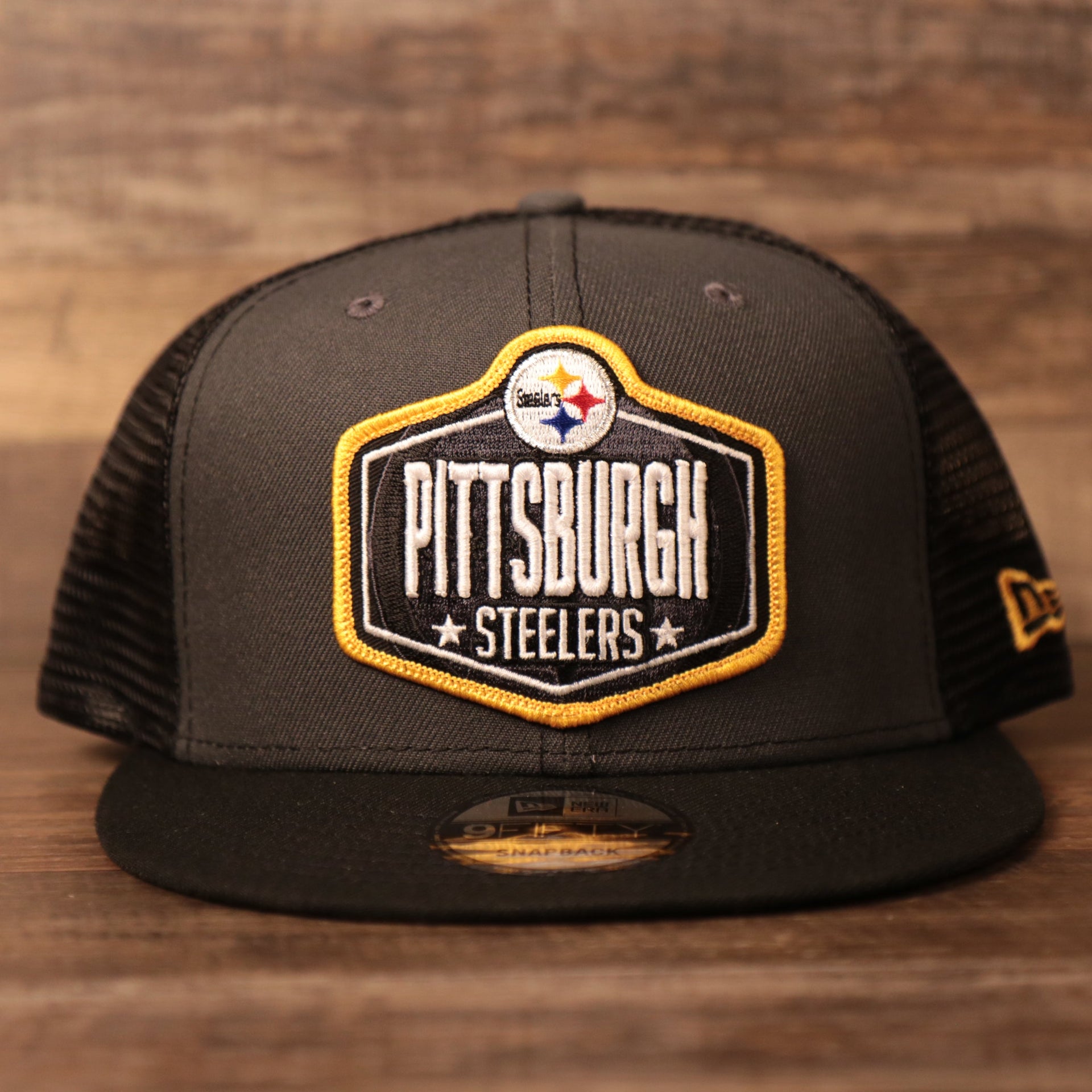 The front side of the gray/black Steelers 9fifty mashback snapback trucker cap for the NFL Draft 2021.