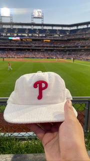 The Corduroy Cooperstown Philadelphia Phillies Snapback Hat | White Corduroy Snap Cap at a baseball game